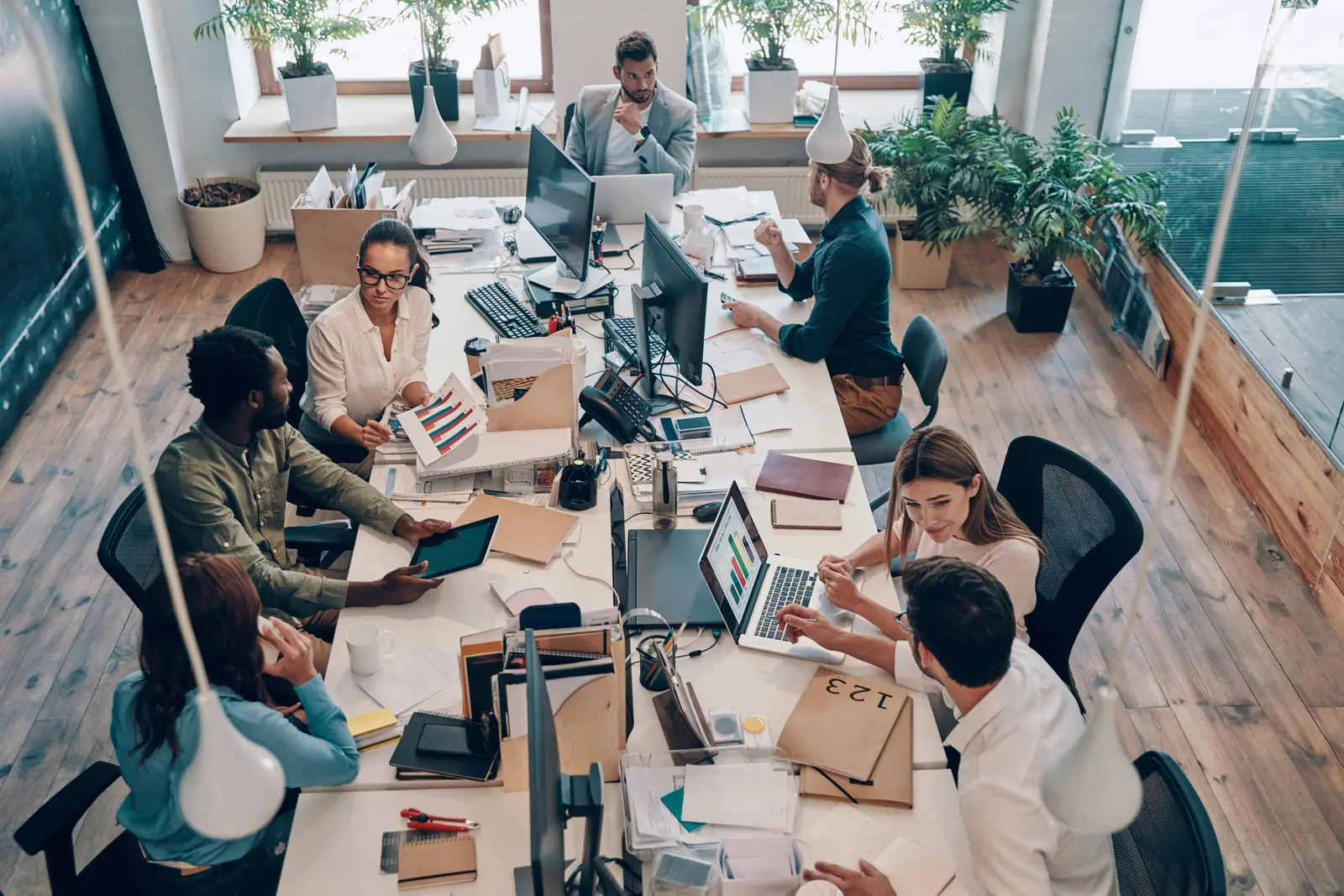 Top-down view of a team working together around a desk
